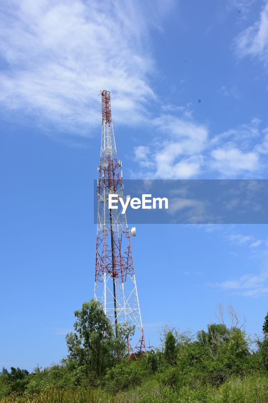 sky, technology, communications tower, tower, global communications, broadcasting, communication, wireless technology, nature, cloud, plant, telecommunications equipment, satellite dish, built structure, satellite, architecture, blue, transmission tower, antenna, overhead power line, no people, low angle view, metal, day, mast, telecommunications engineering, outdoors, radio, tree, land, electricity, environment, power generation, industry, landscape, equipment, television industry, steel, wind, copy space
