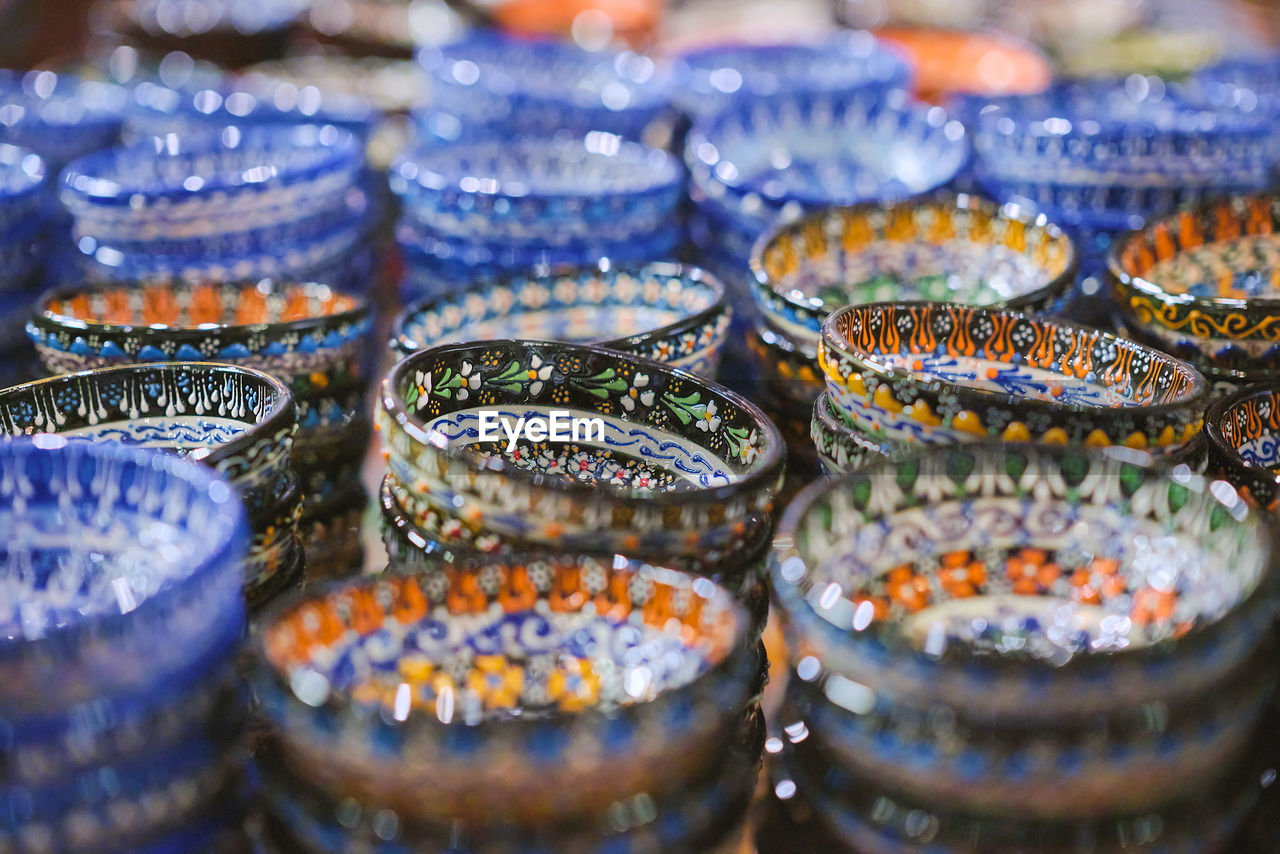 Traditional turkish ceramics, pottery, bowl at the bazaar. selective focus and blurred background. 