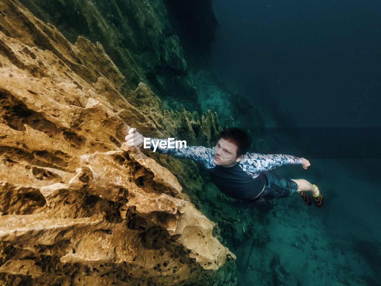 High angle view of man climbing on rock