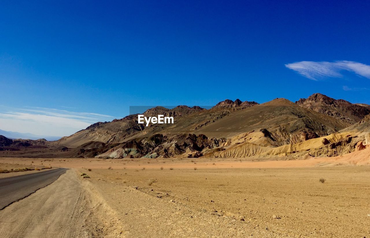 Scenic view of landscape against blue sky