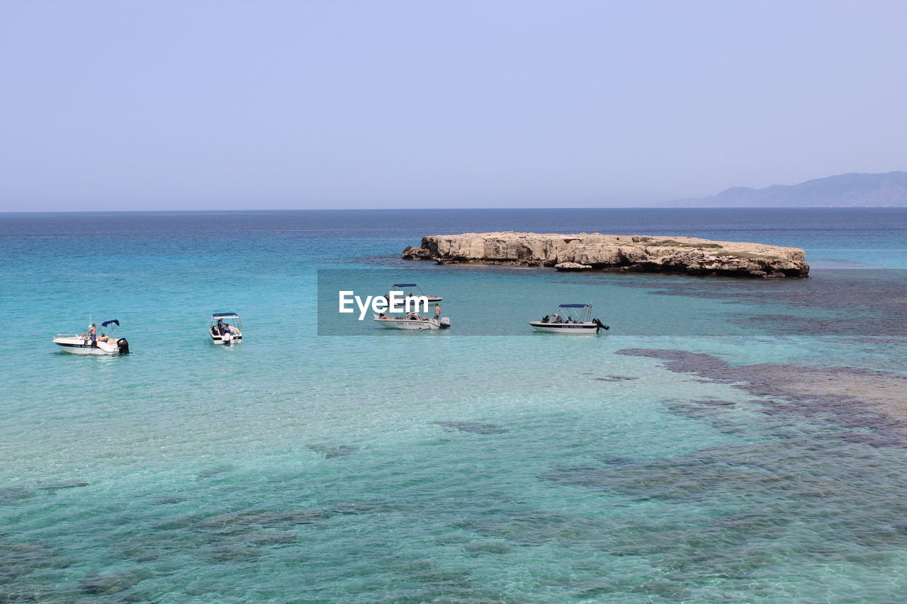 VIEW OF BOATS IN SEA AGAINST CLEAR SKY