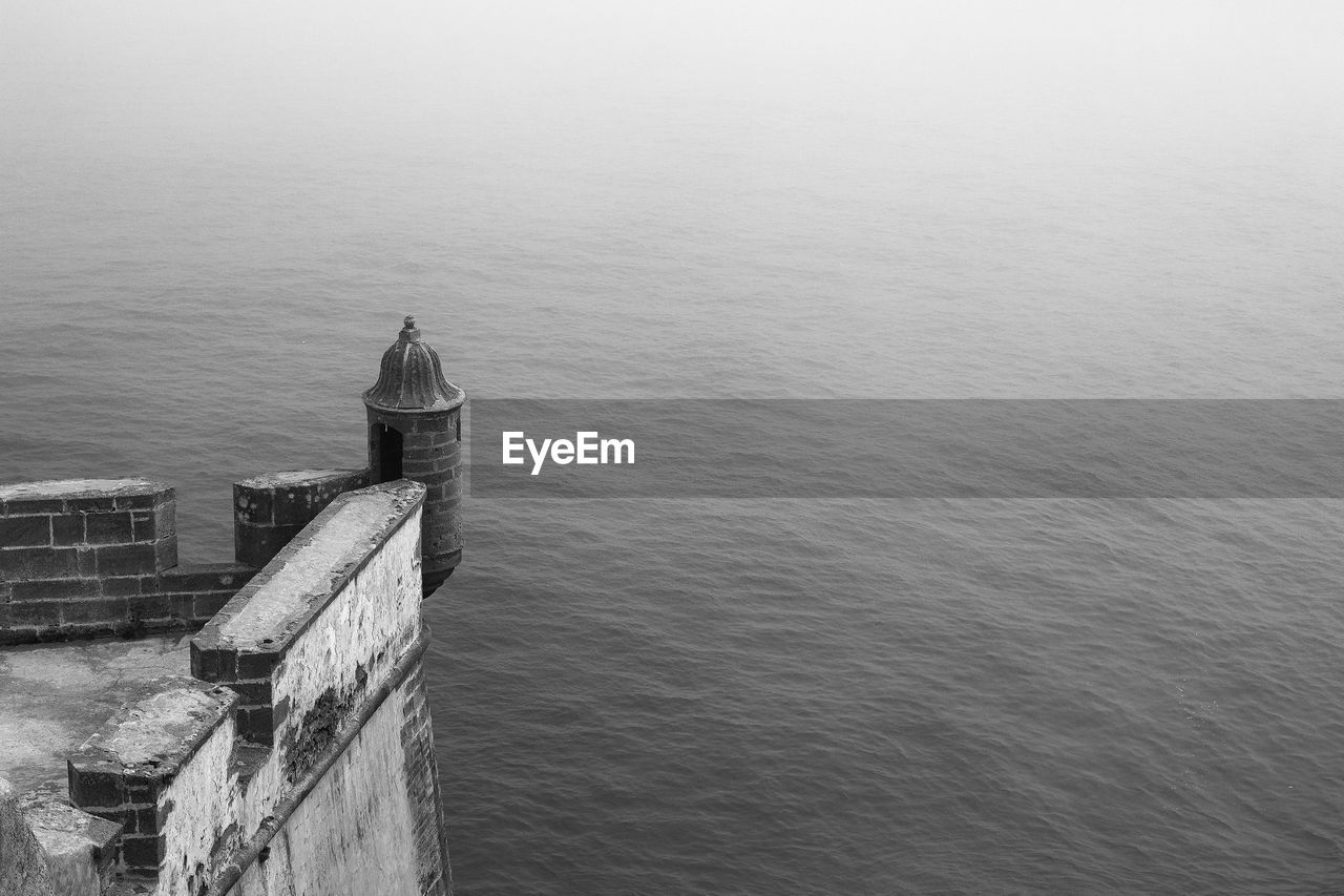 High angle view of building by sea against sky