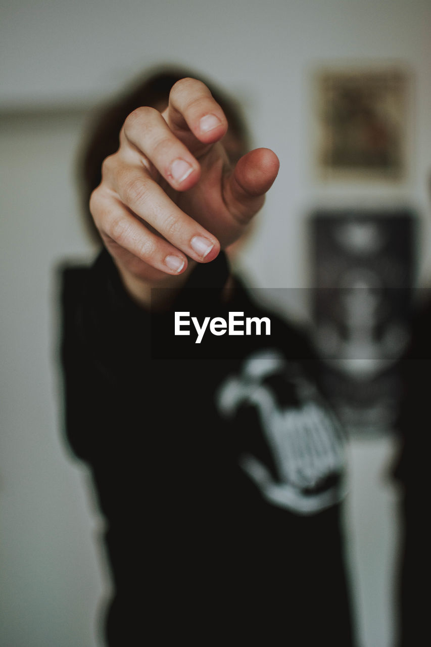 Woman gesturing while standing at home