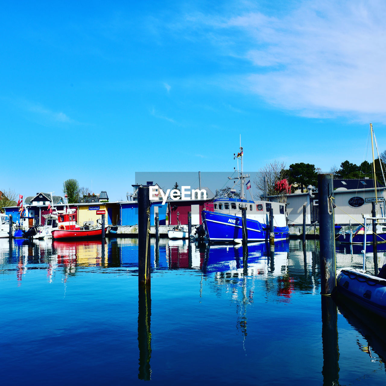 water, sky, transportation, nautical vessel, sea, mode of transportation, dock, nature, marina, reflection, harbor, vehicle, moored, blue, cloud, architecture, pier, travel destinations, vacation, ship, boat, day, travel, waterfront, outdoors, ocean, no people, built structure, body of water, building exterior, city, dusk, watercraft, port