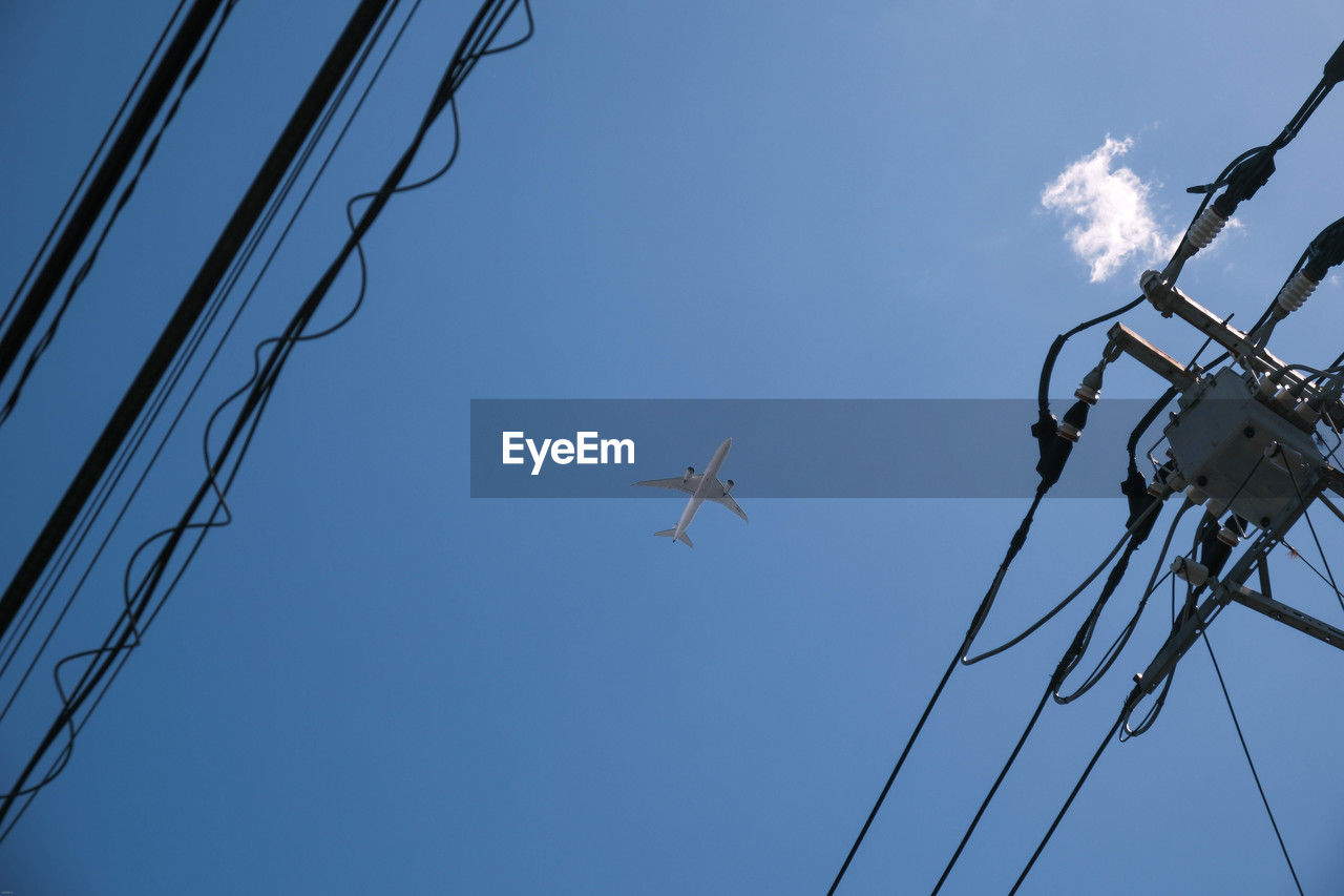 low angle view of airplane flying against clear sky