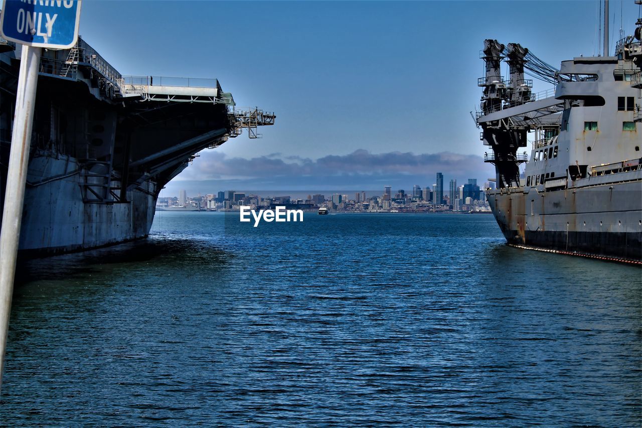 SCENIC VIEW OF SEA BY BUILDINGS AGAINST SKY IN CITY