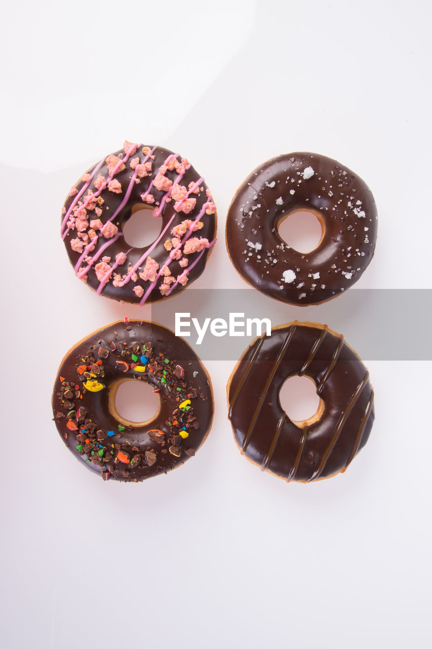 Close-up of donuts over white background