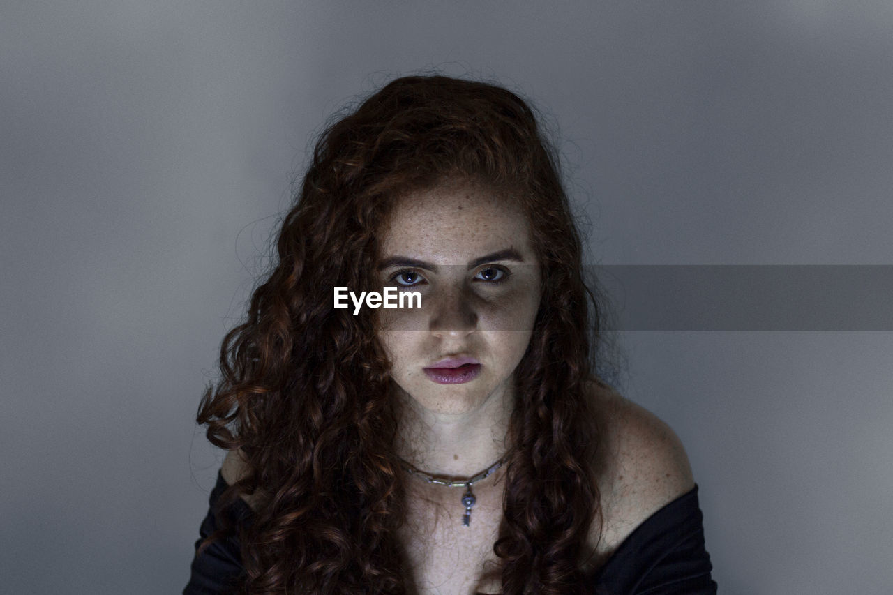 Portrait of a beautiful young woman over white background