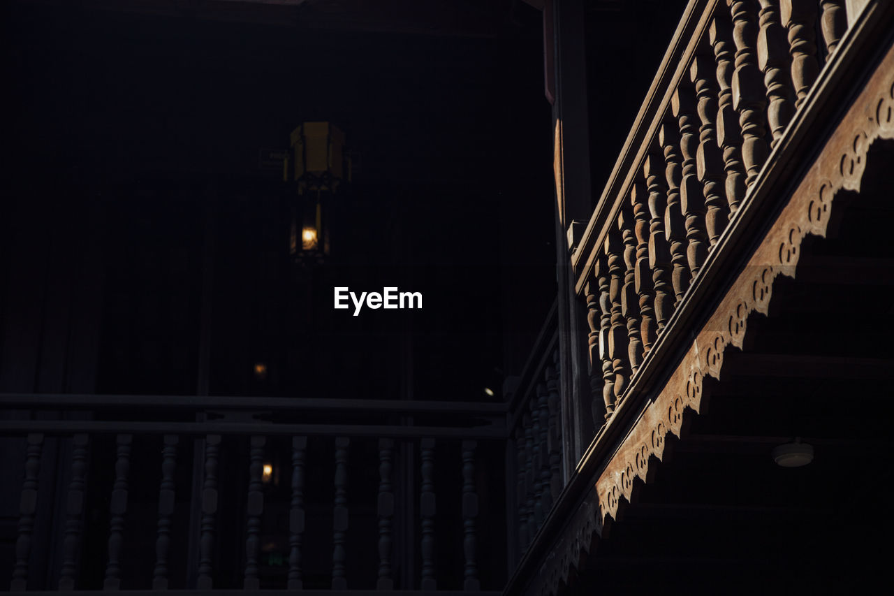 Low angle view of illuminated staircase in building at night