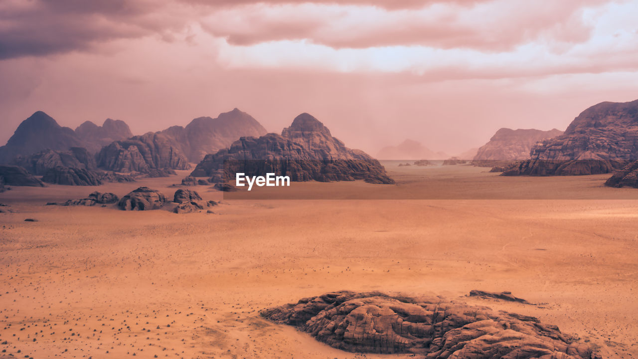 Storm and rain clouds over the desert landscape of wadi rum in jordan. panoramic shot