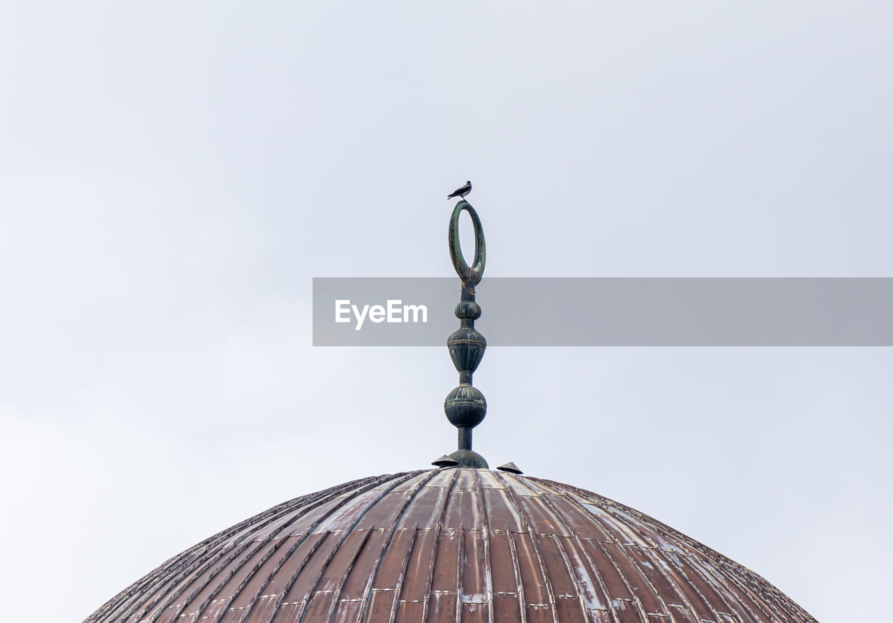 Low angle view of dome of mosque against clear sky