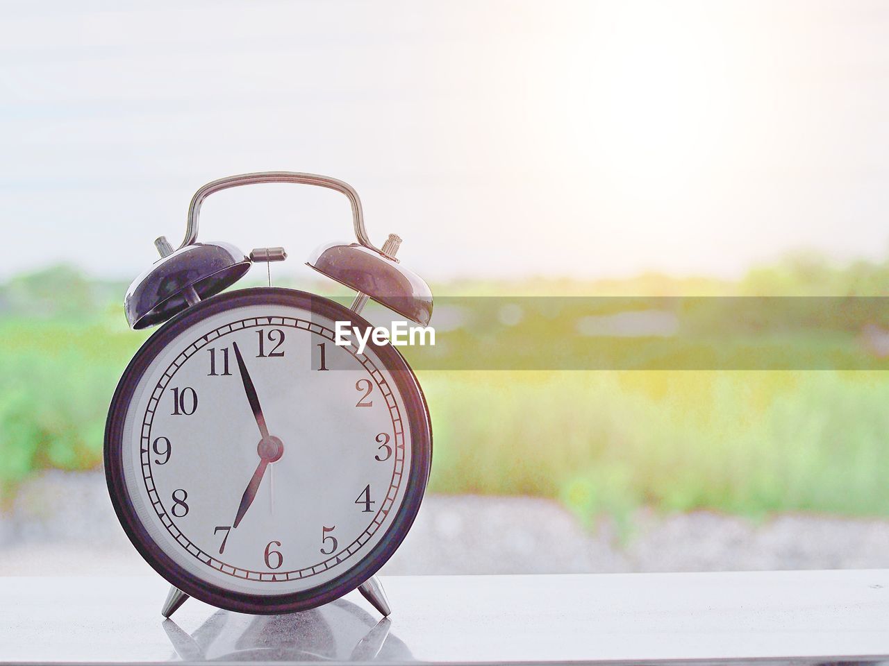 Close-up of clock against sky