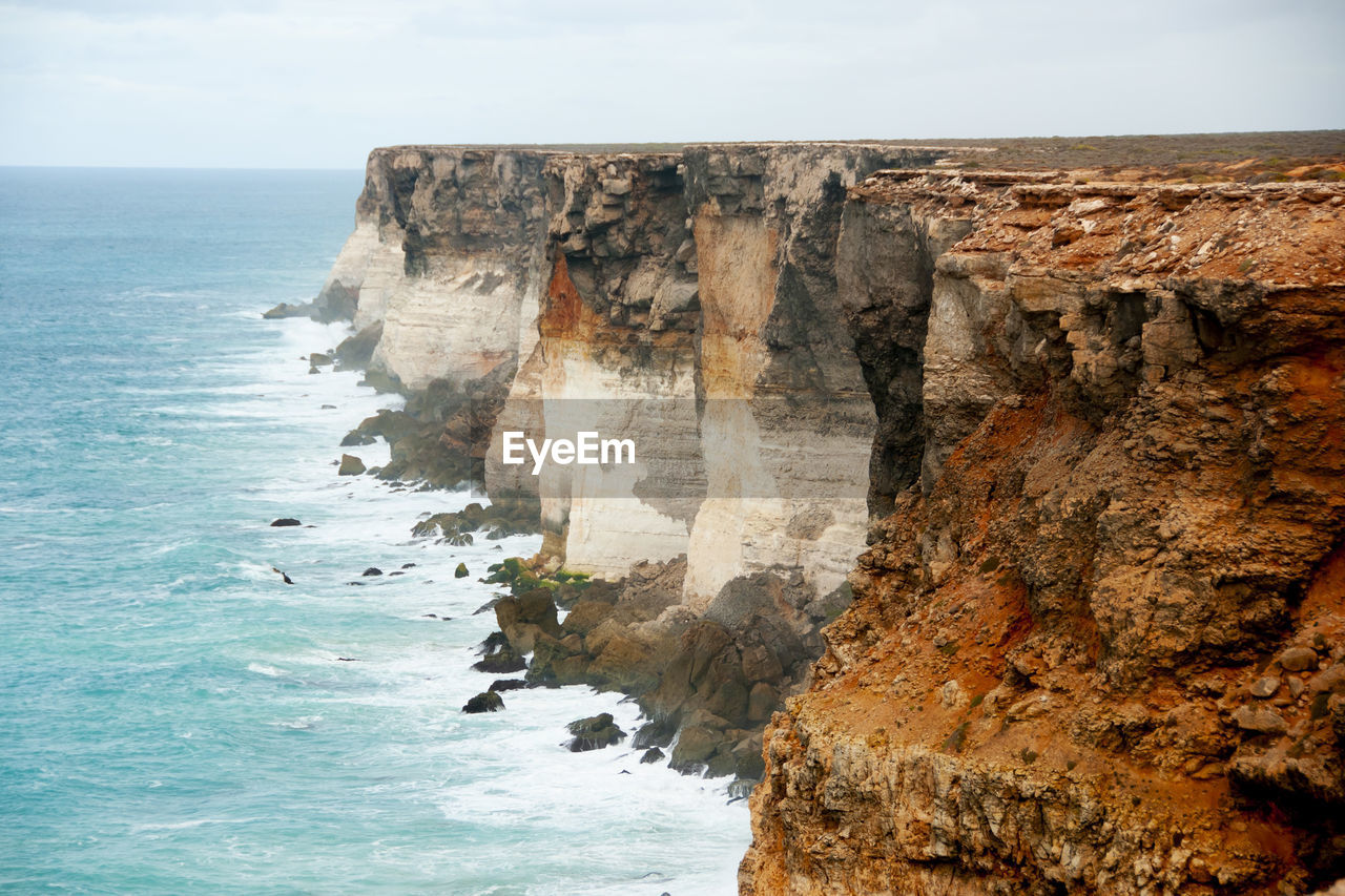 sea, water, cliff, rock, coast, land, beauty in nature, scenics - nature, beach, ocean, rock formation, nature, sky, terrain, horizon over water, shore, horizon, tranquility, tranquil scene, no people, formation, non-urban scene, day, coastline, wave, bay, travel destinations, idyllic, outdoors, body of water, travel, environment, geology, motion, natural arch, seascape, cloud