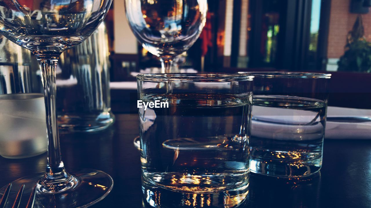 Close-up of drinking glasses on table