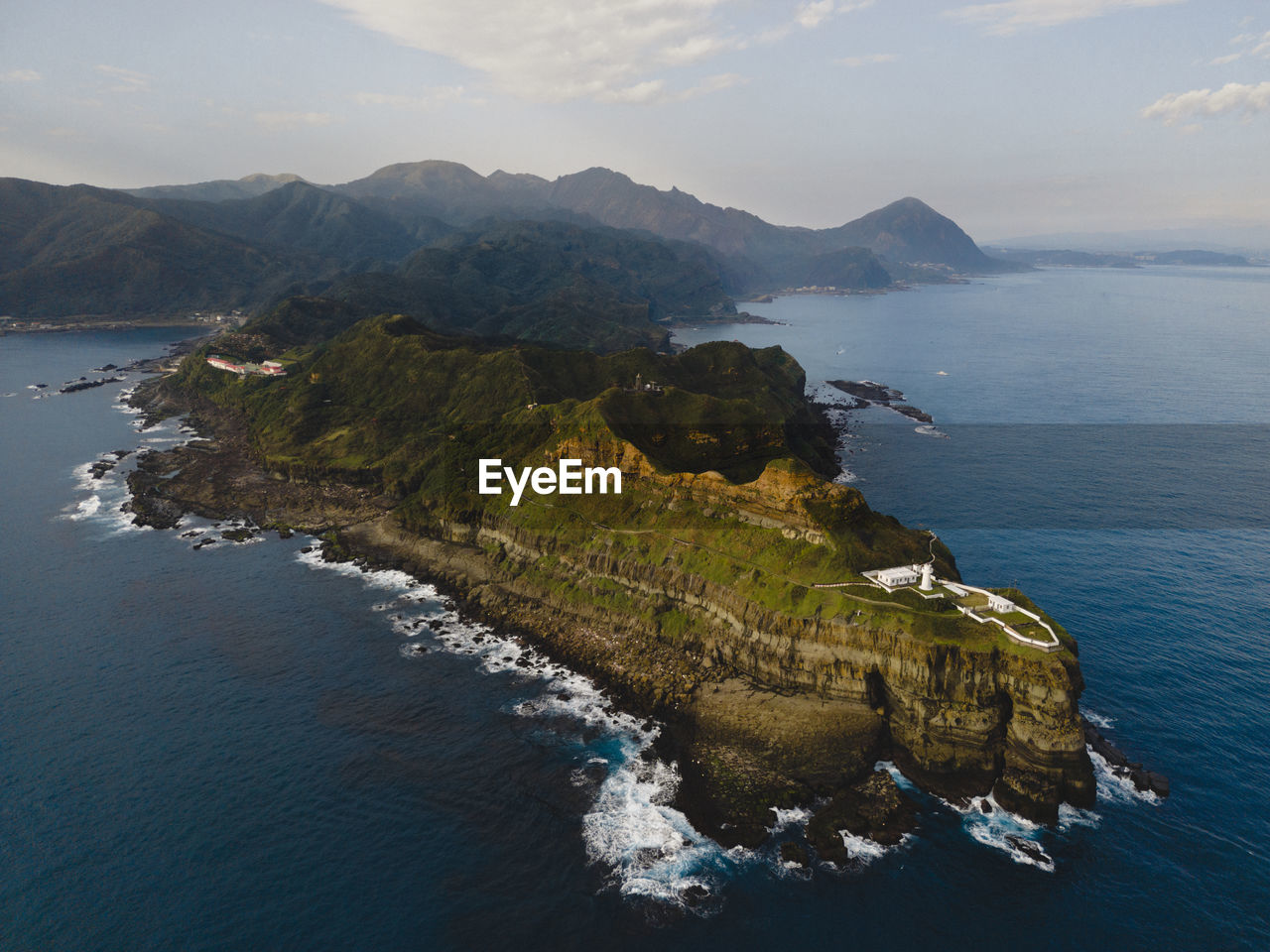 High angle view of sea and mountains against sky