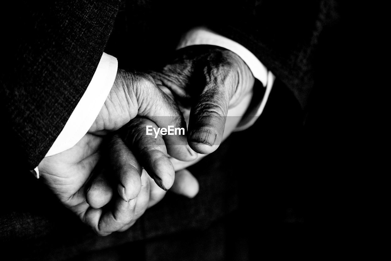 Close-up of man hands against black background