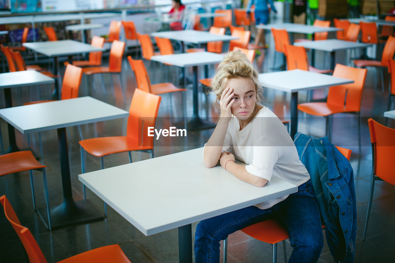 Woman sitting on chair at supermarket