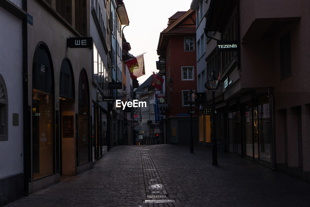 EMPTY ALLEY AMIDST BUILDINGS