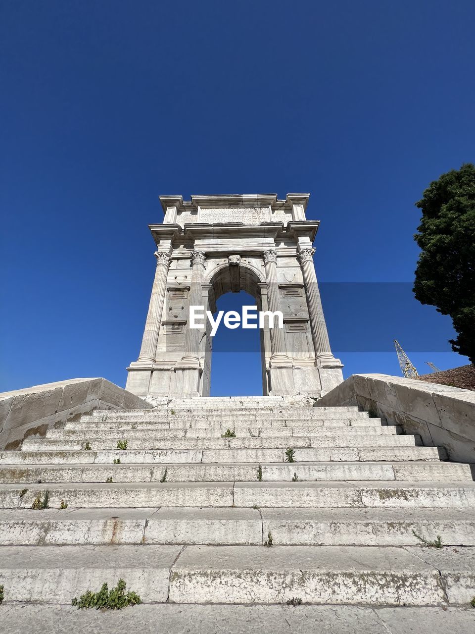 architecture, blue, built structure, sky, clear sky, landmark, history, the past, nature, building exterior, tower, no people, travel destinations, low angle view, day, sunny, travel, outdoors, religion, building, tourism, old, wall, belief, old ruin, city, ancient, sunlight, facade, place of worship, tree, wall - building feature