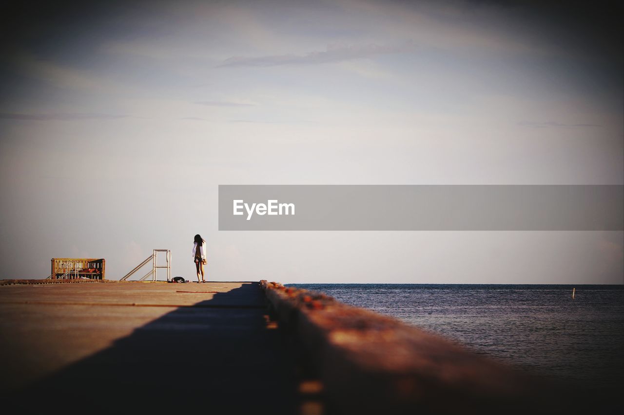 Surface level of woman on pier