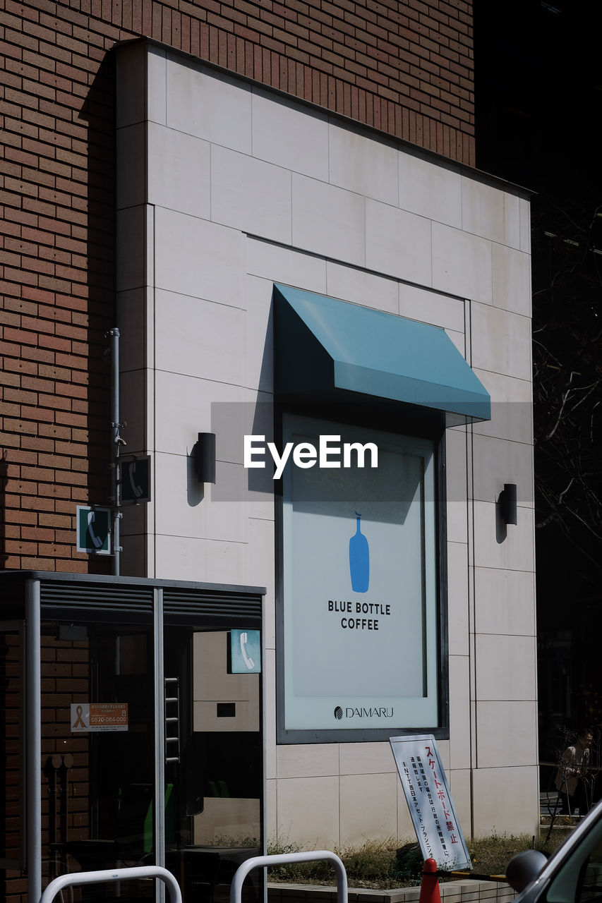 LOW ANGLE VIEW OF SIGN AGAINST BUILDING