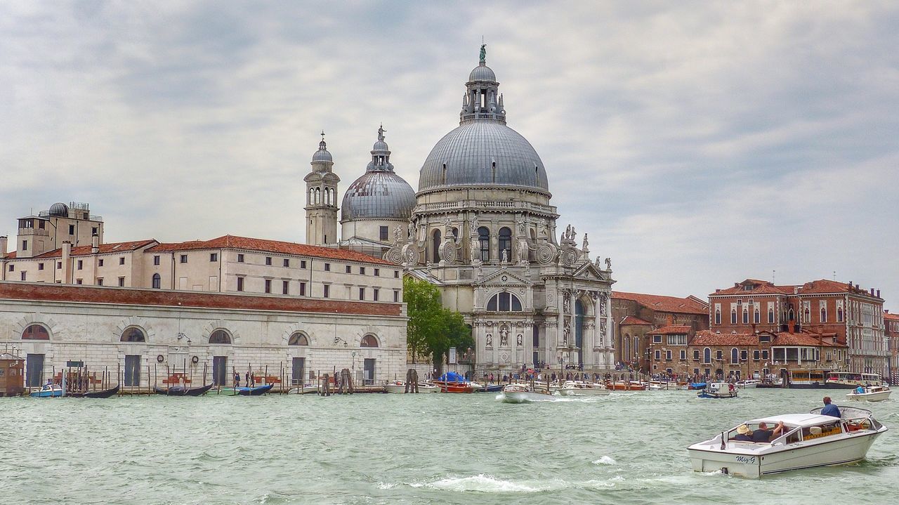 Santa maria della salute by canal against sky