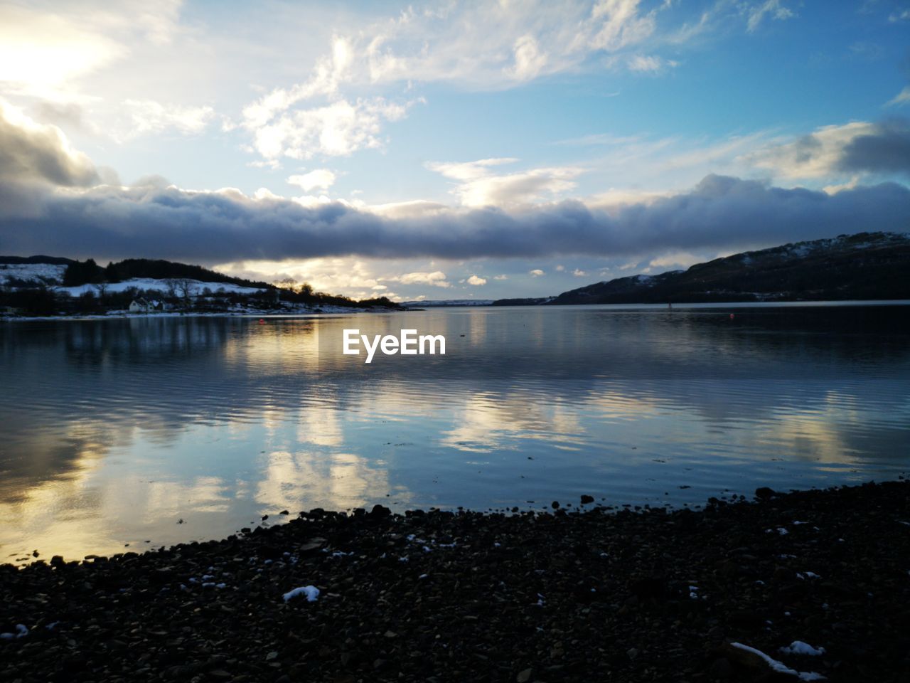 SCENIC VIEW OF LAKE AT SUNSET