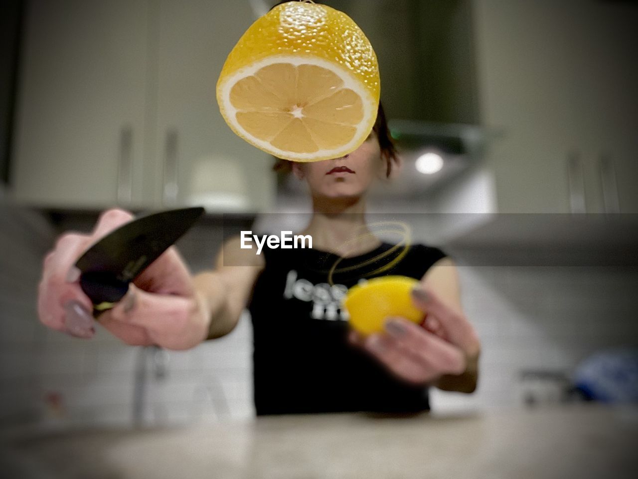Lemon cut in half by a woman