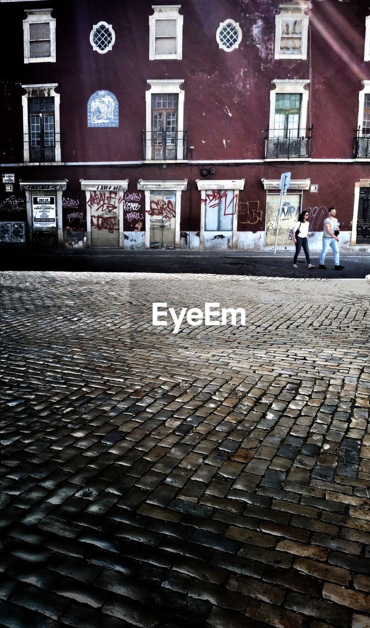 HIGH ANGLE VIEW OF PEOPLE ON STREET