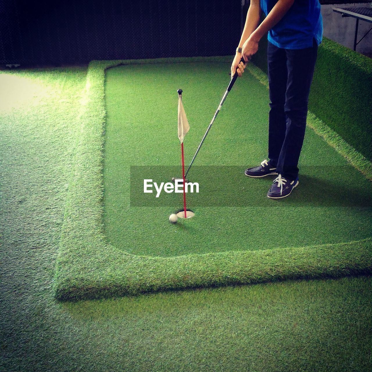 Low section of man playing golf at grassy field