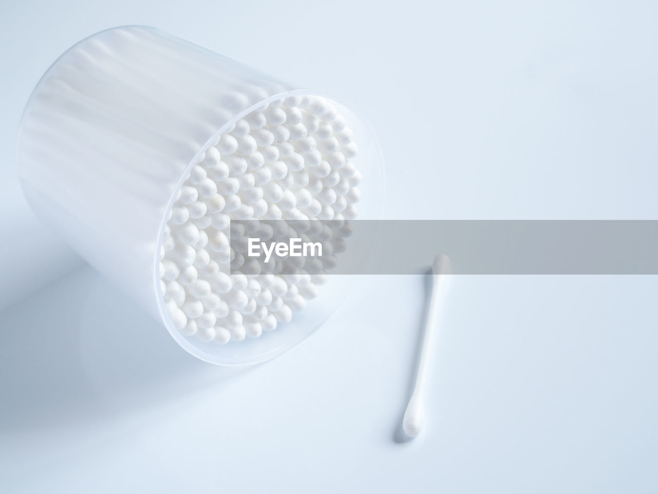 HIGH ANGLE VIEW OF WHITE FLOWER ON TABLE AGAINST GRAY BACKGROUND