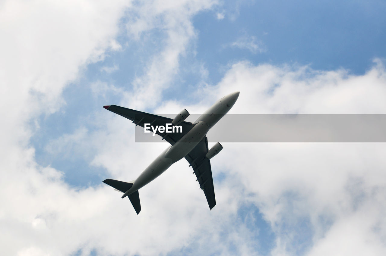 Low angle view of airplane flying in sky