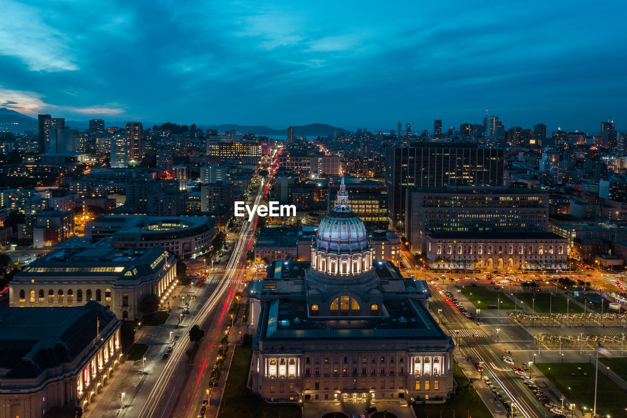 High angle view of city lit up at night