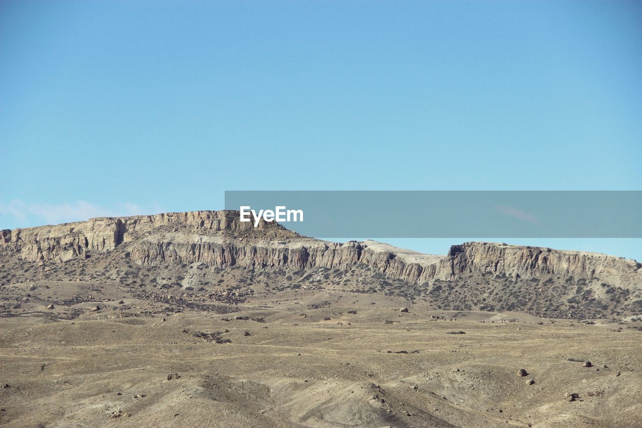 Scenic view of rocky mountains against clear blue sky