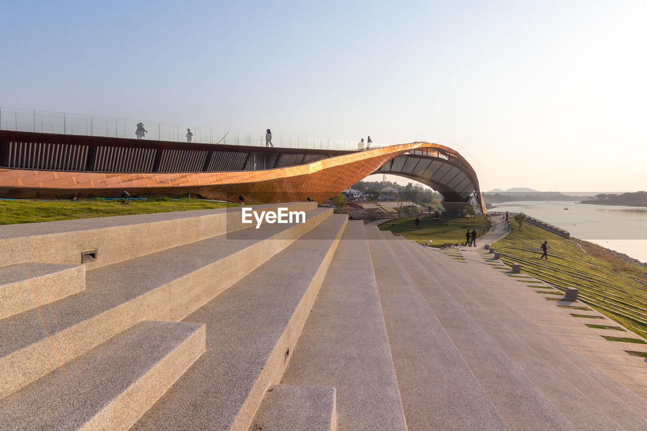 Road by bridge against clear sky