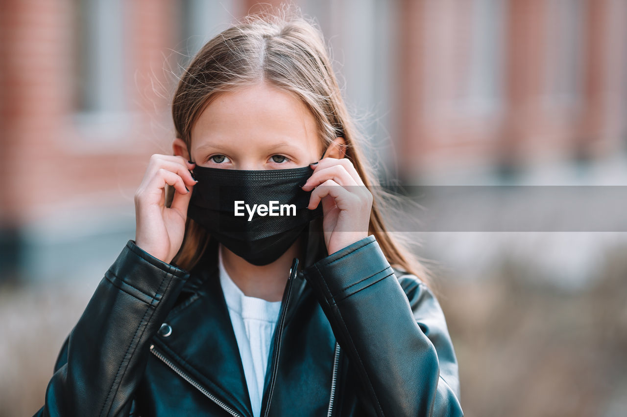 PORTRAIT OF A GIRL HOLDING CAMERA