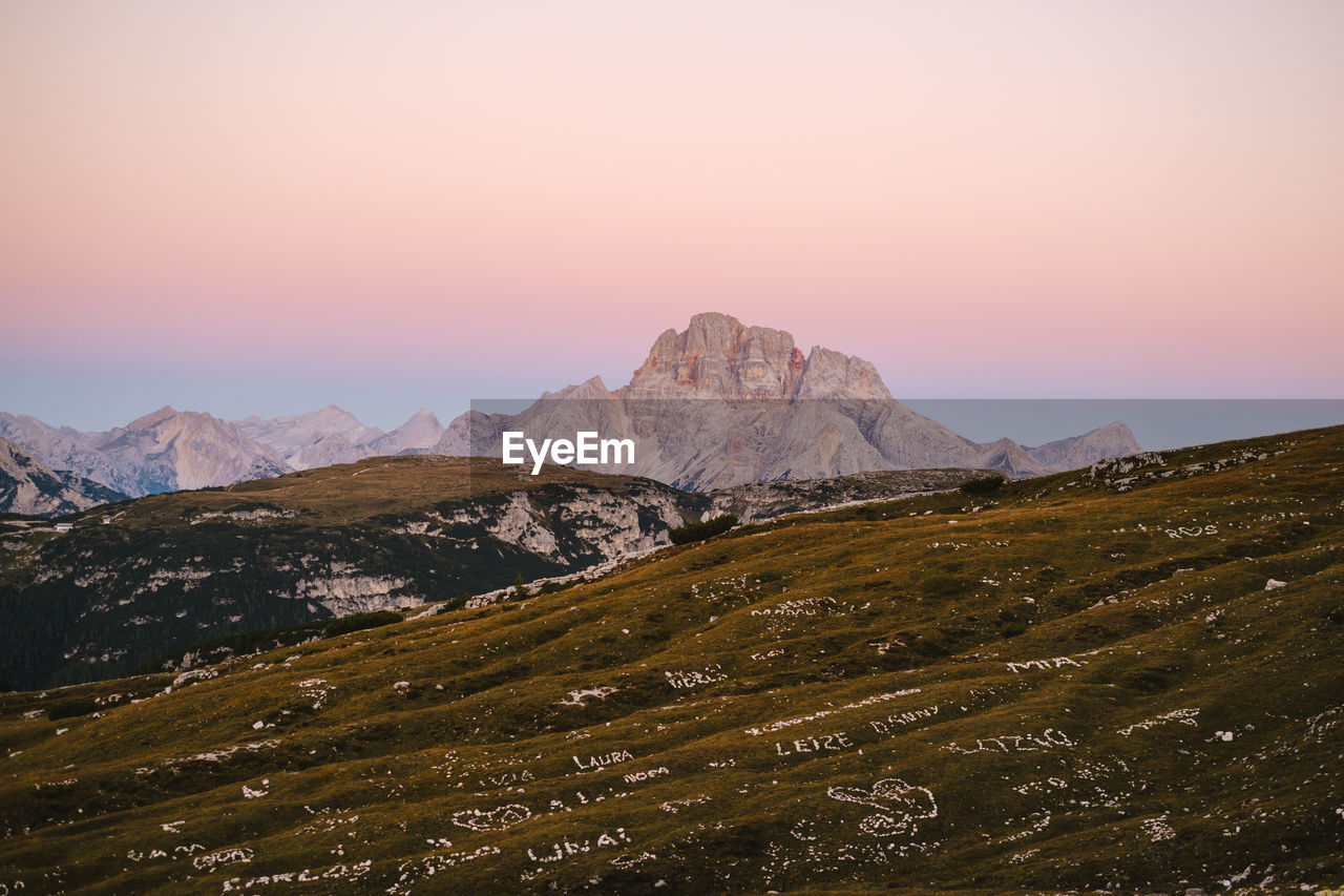 scenic view of mountains against clear sky during sunset