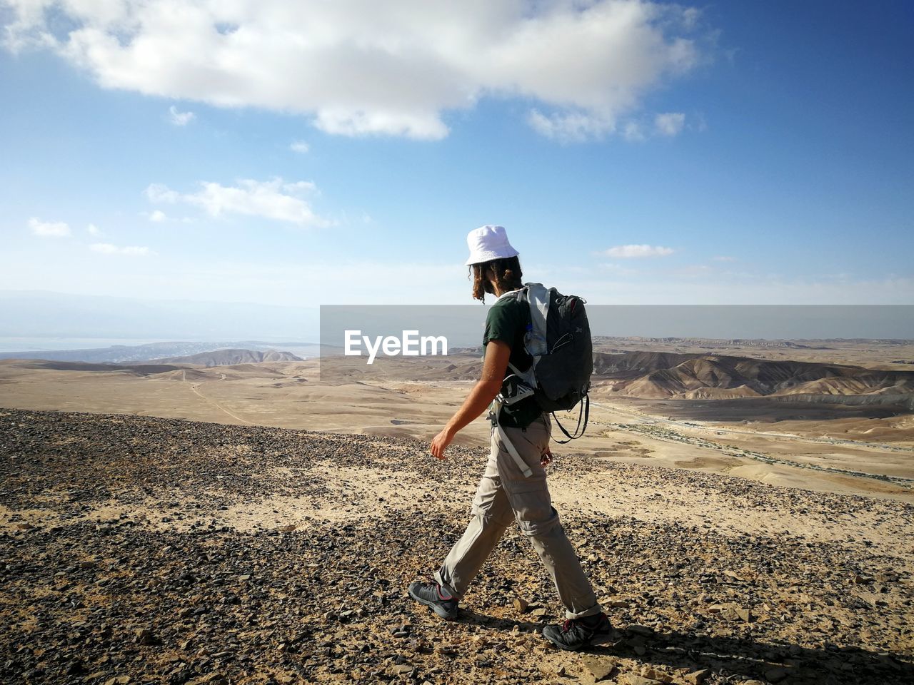 Side view of man with backpack walking on land