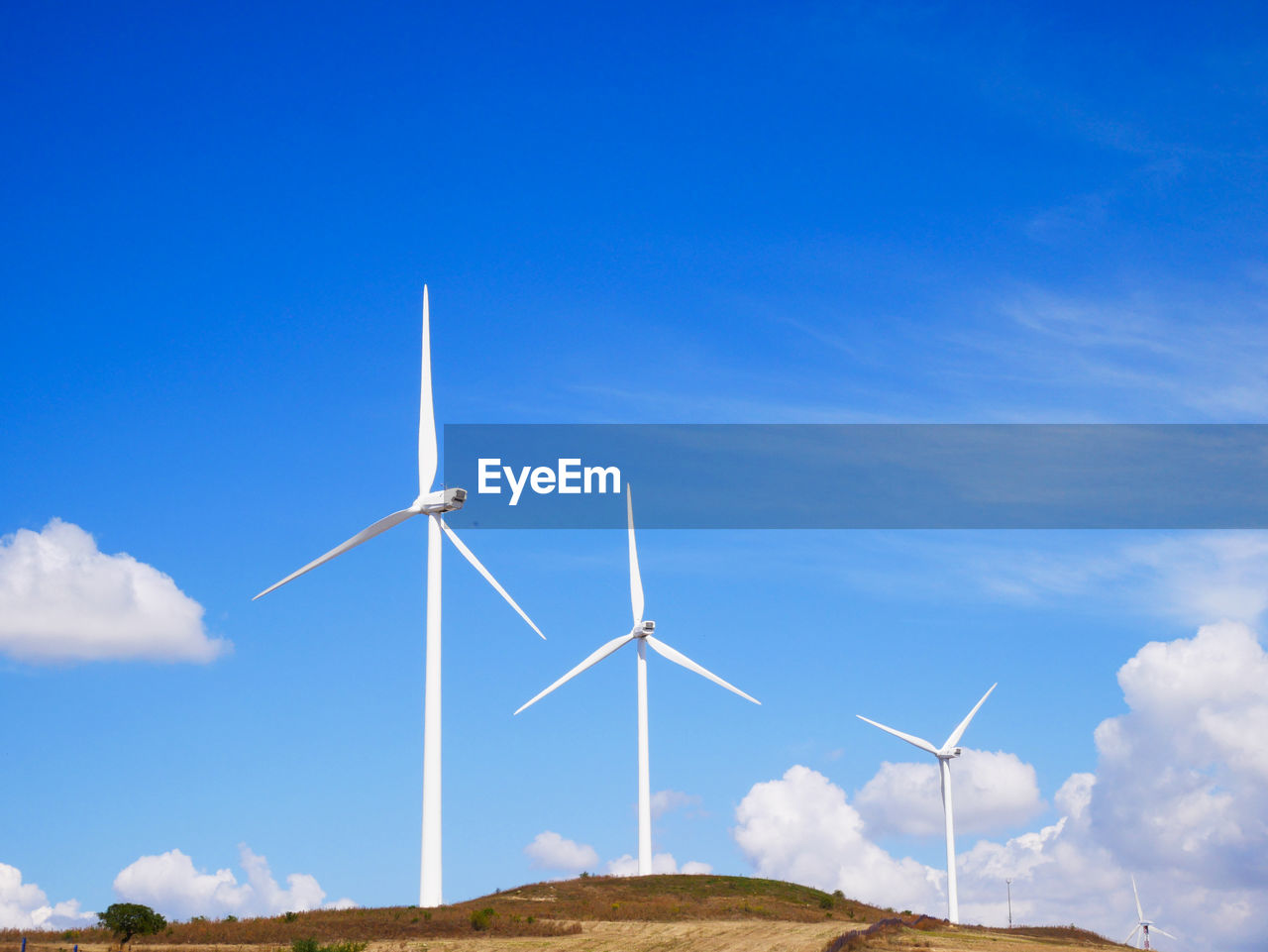 LOW ANGLE VIEW OF WINDMILLS AGAINST SKY