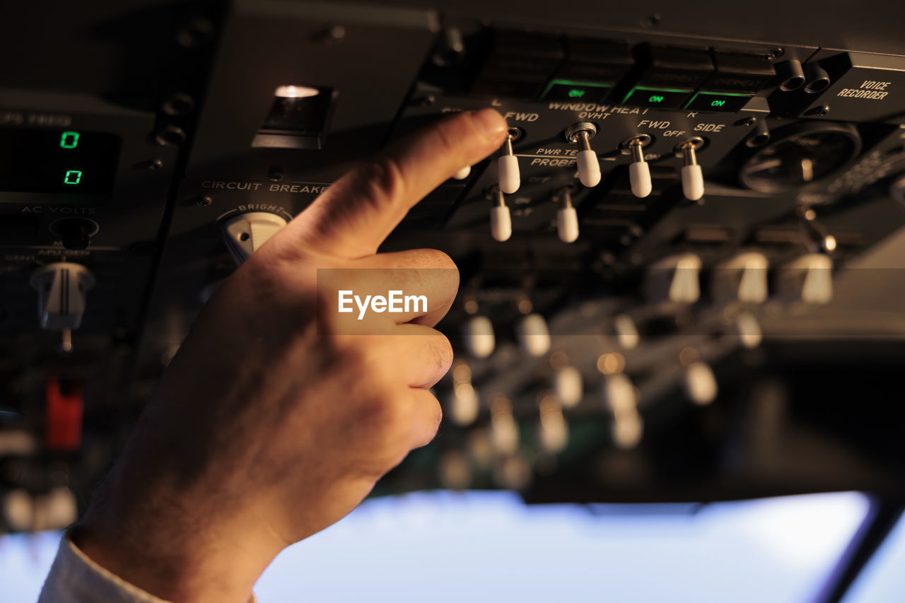 cropped hand of man using sound mixer