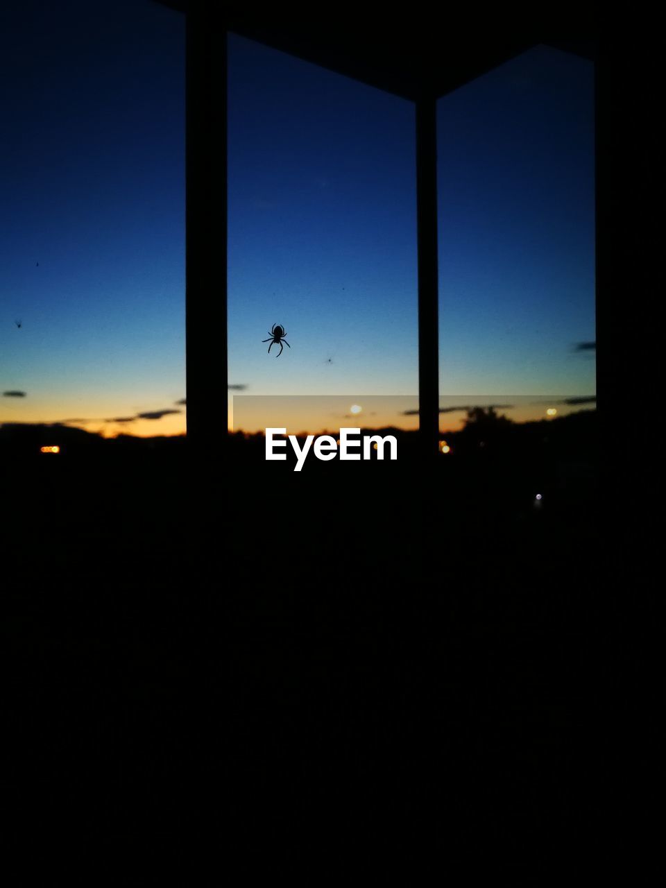 SILHOUETTE OF AIRPLANE WINDOW AGAINST SKY