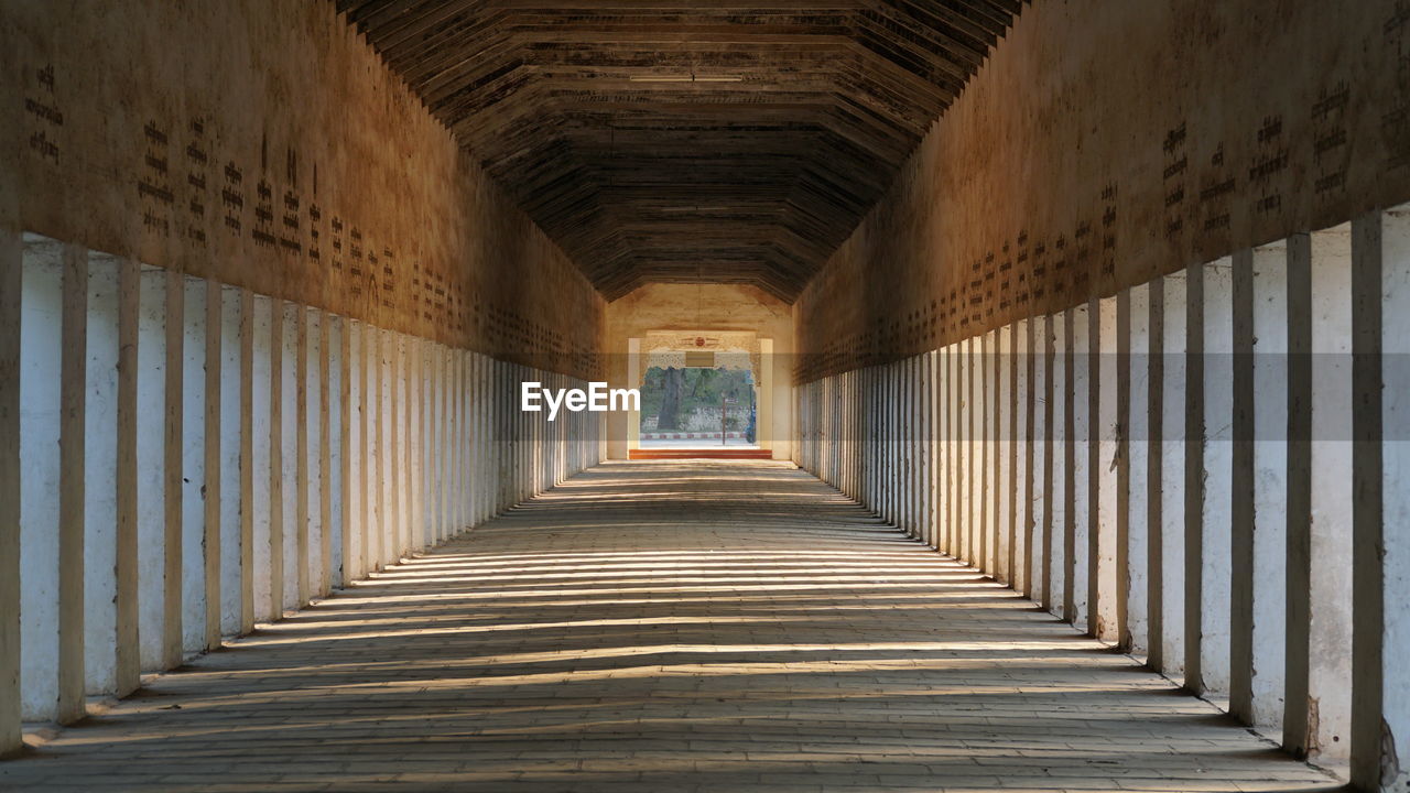 EMPTY CORRIDOR OF BUILDING WITH COLONNADE