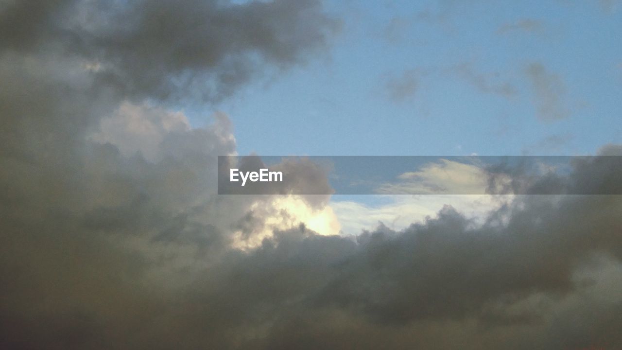 LOW ANGLE VIEW OF SKY AND CLOUDS IN SUNLIGHT