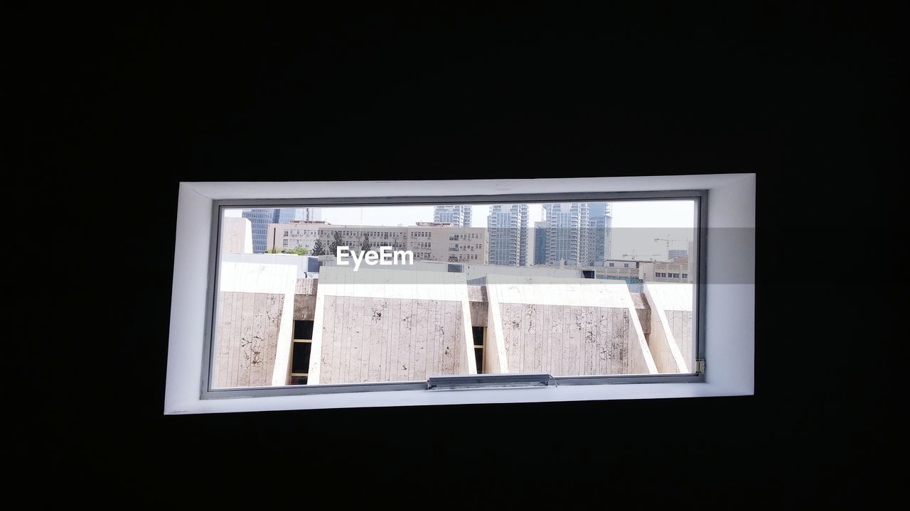 Buildings in city seen through window