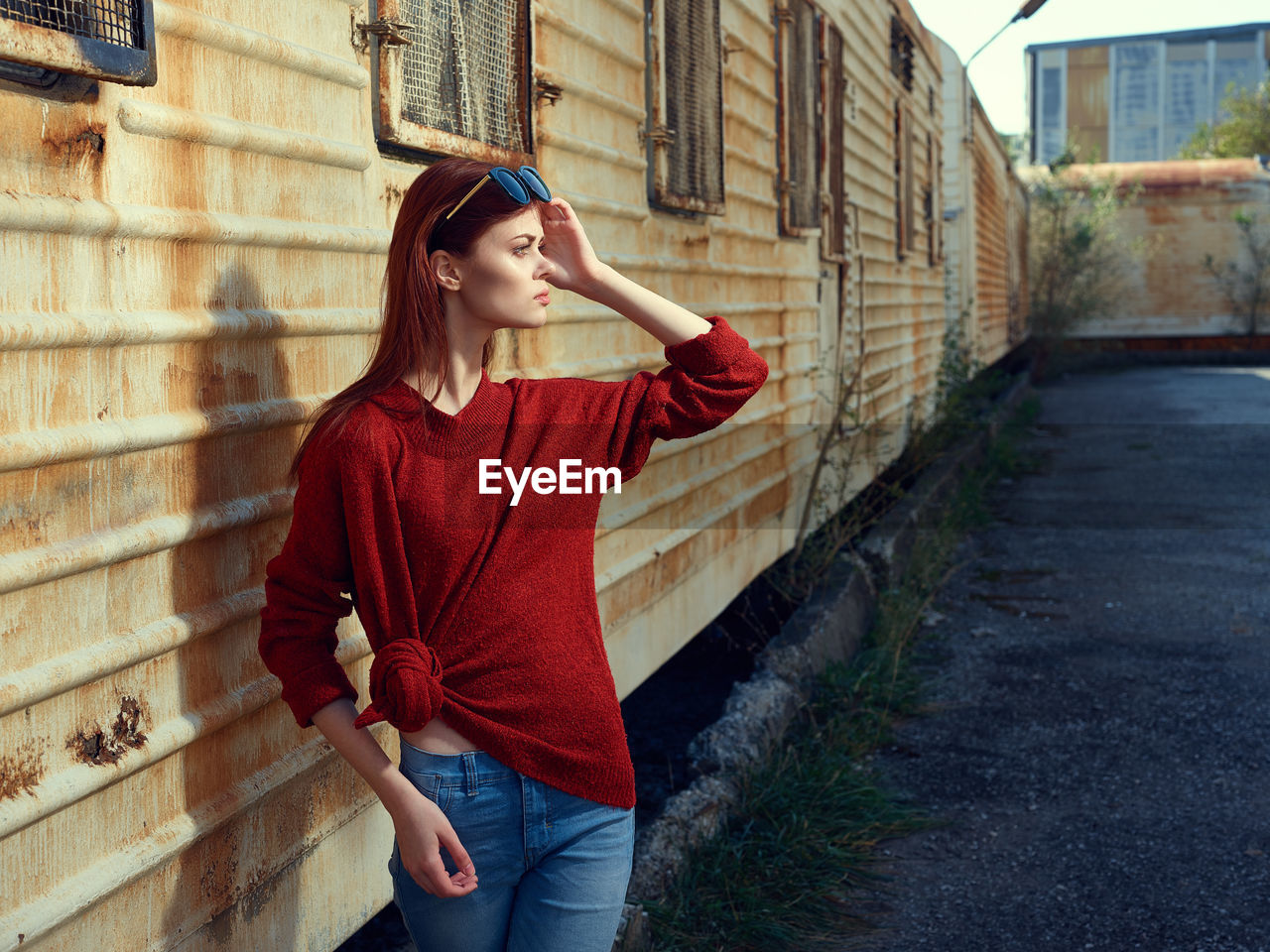 rear view of young woman standing against canal