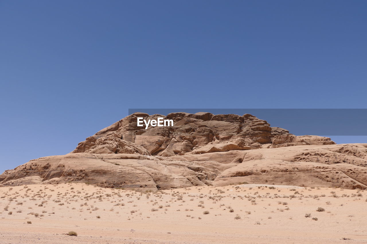 Rock formations in wadi rum  against clear blue sky