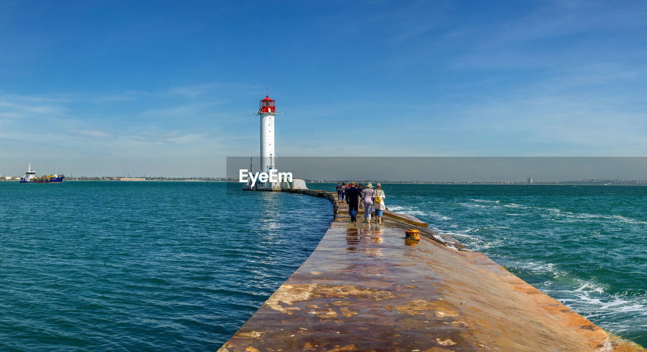 Excursion to odessa lighthouse in the harbor of odessa seaport, on a sunny summer day