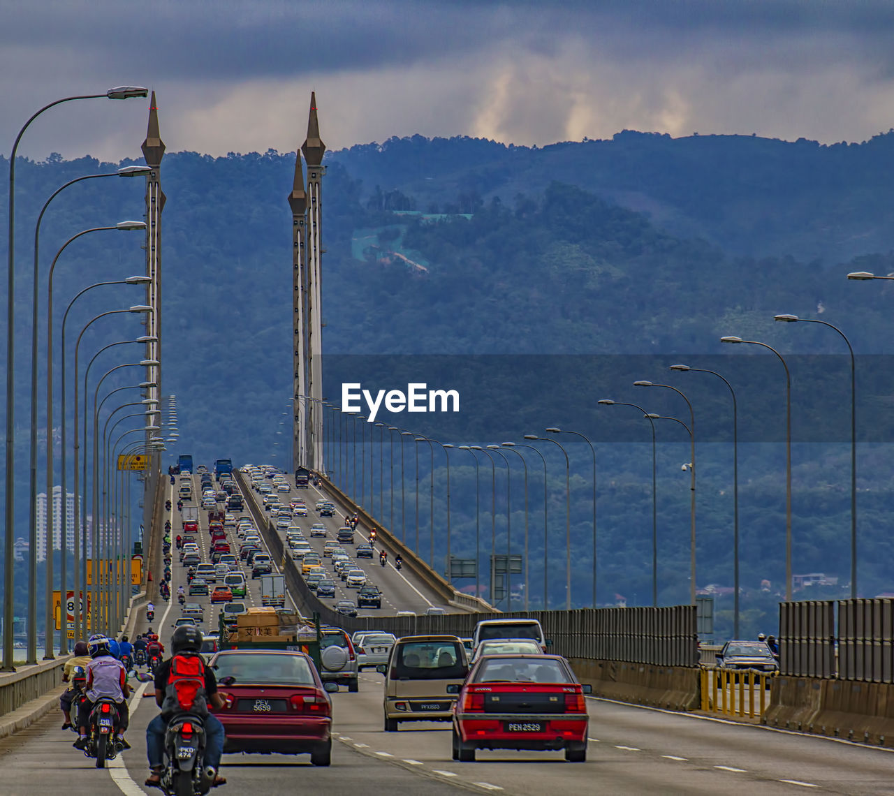 VEHICLES ON ROAD AGAINST SKY