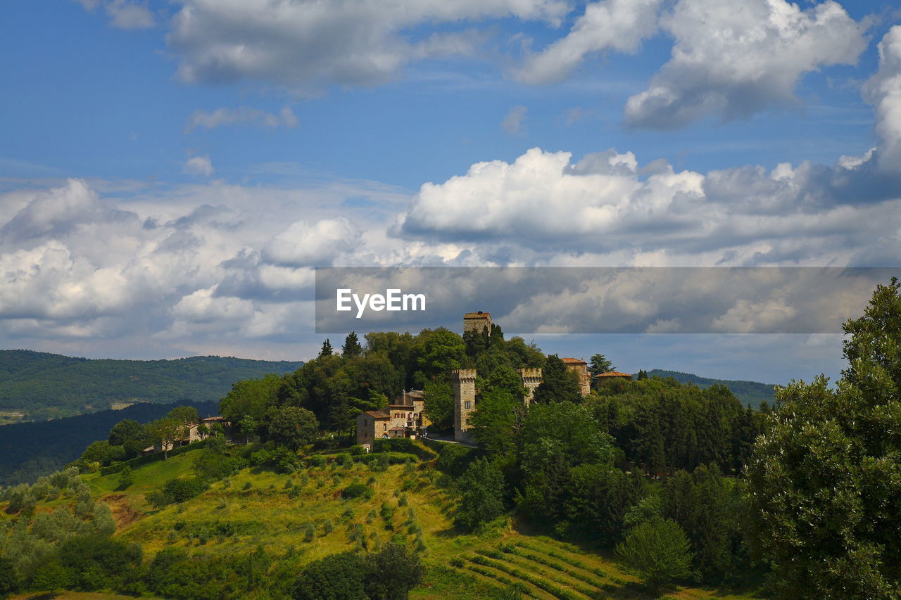 Panoramic view of green landscape and medieval village, chianti region tuscany 