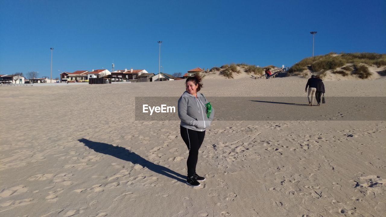 WOMEN WALKING ON BEACH